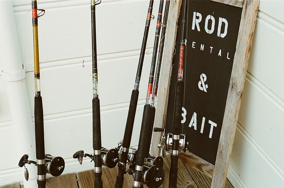 fishing rods, sports, bait, sign, wood, text, communication, western script, fuel and power generation, day