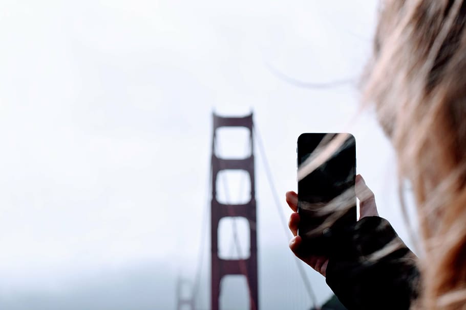 person, taking, golden, gate bridge, bridge, architecture, blur, phone, hand, hair
