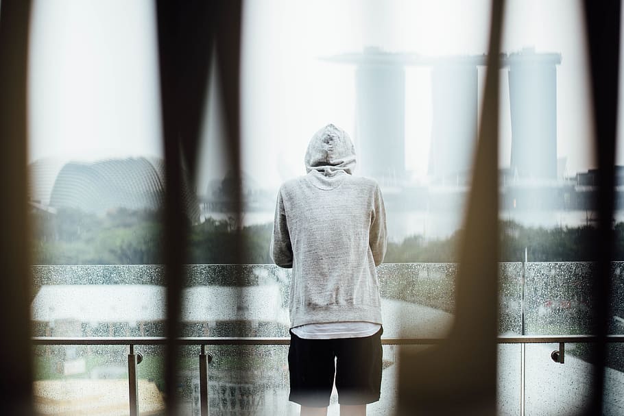 man, standing, balcony, facing, marina bay sands, singapore, alone, hoodie, sad, thinking