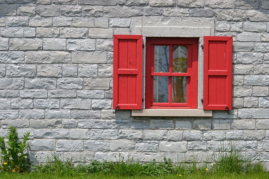 red, wooden, frame glass center window, surrounded, grey, concrete, wall, wooden frame, glass, center