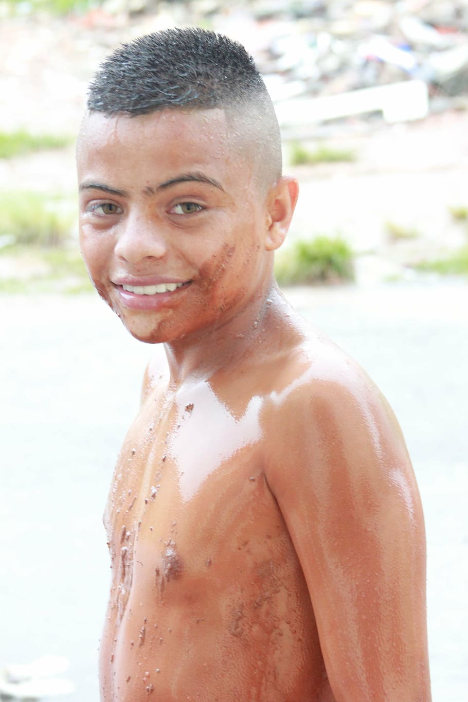 child, dirty, clay, one person, portrait, shirtless, looking at camera, smiling, focus on foreground, leisure activity