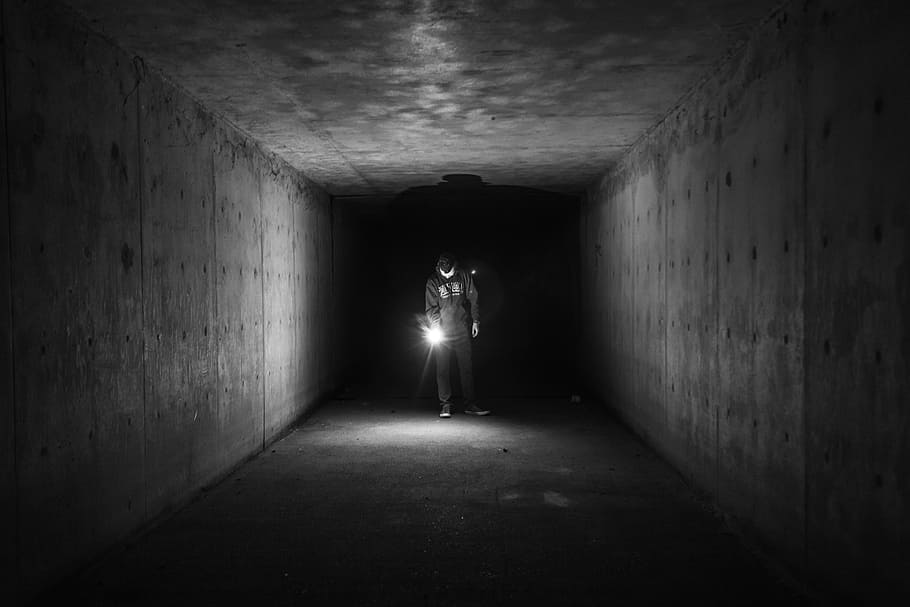 grayscale photo, man, holding, lamp, inside, tunnel, flashlight, dark, underground, guy