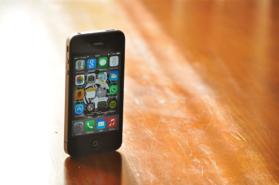 black, iphone 4, displaying, interface screen, placed, brown, wood surface, iphone, smartphone, phone