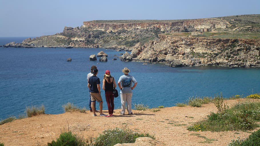gnejna bay, rocks, cliffs, malta, coast, tourists, sea, limestone, wild flowers, water