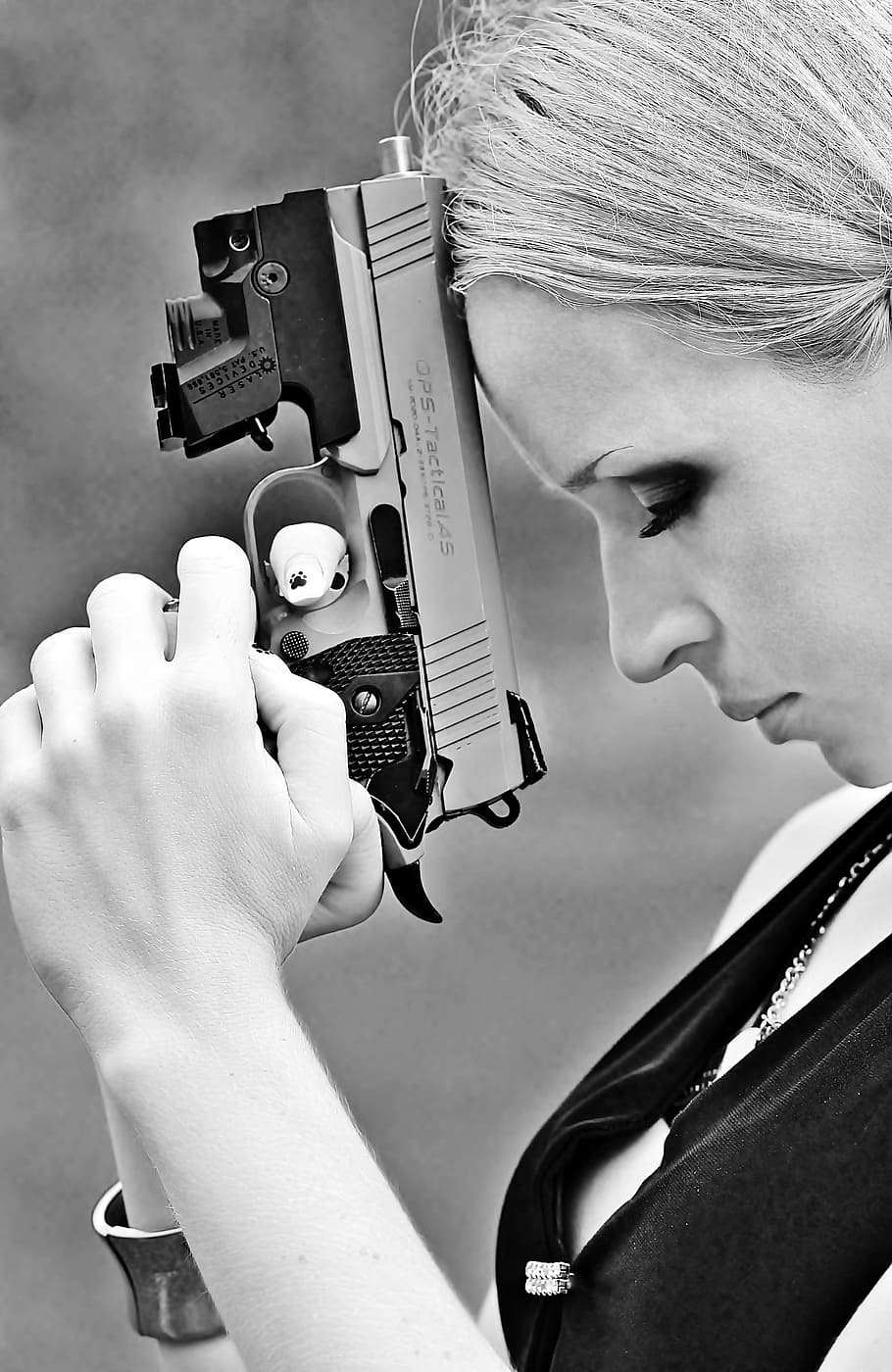 woman holding handgun, weapon, pistol, woman, pray, anger, black white, holding, headshot, portrait