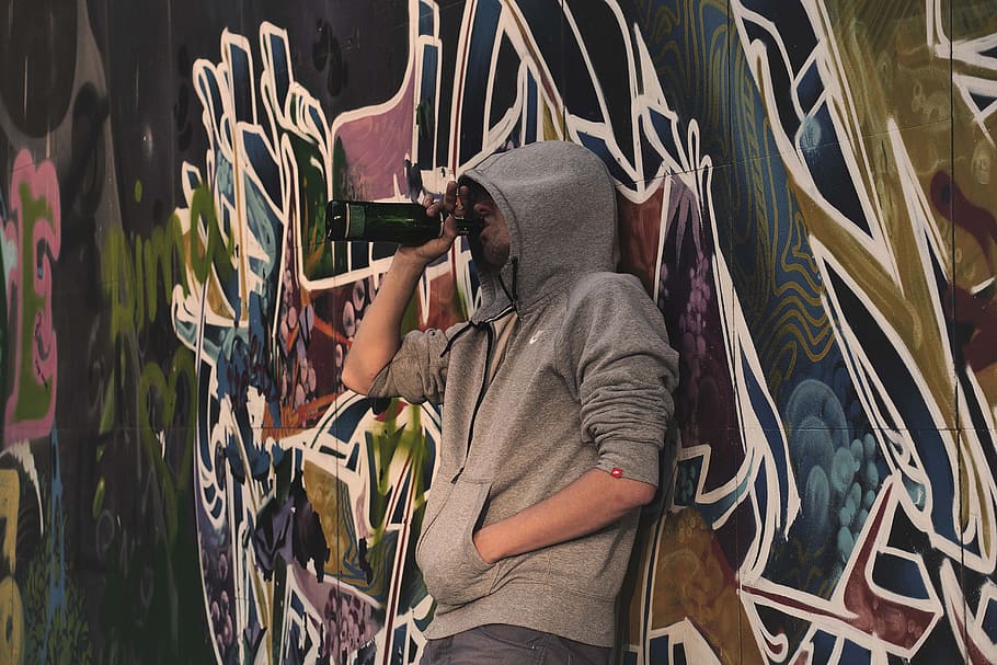 man, leaning, graffiti, tagged, wall, drinking beverage, bottle, binge, alcohol, drink