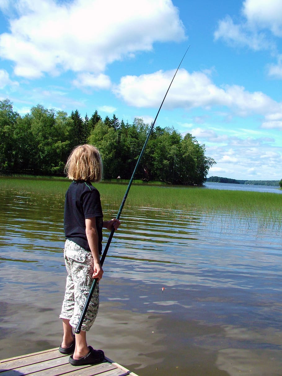 child, fish, hook and line, pier, water, reed, tree, sky, cloud, real people