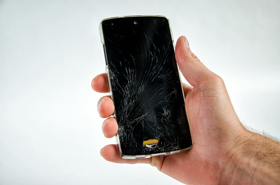 person, holding, black, smartphone, displaying, screen, broken, damaged, defect, cellphone