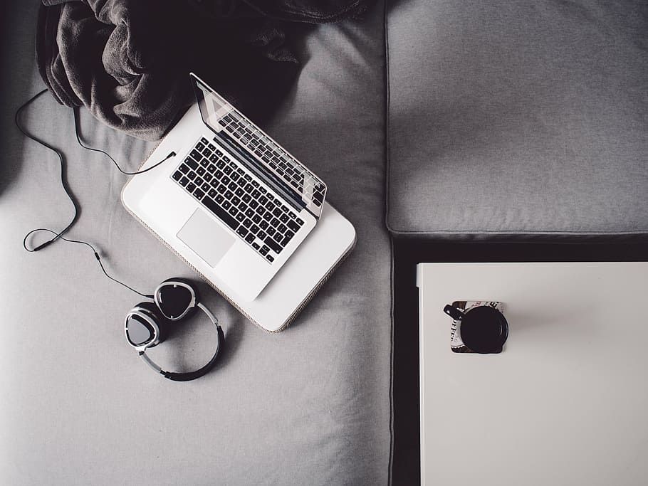 grayscale photography, turned-on macbook, white, laptop, computer, headphones, bed, macbook, deck, black and white