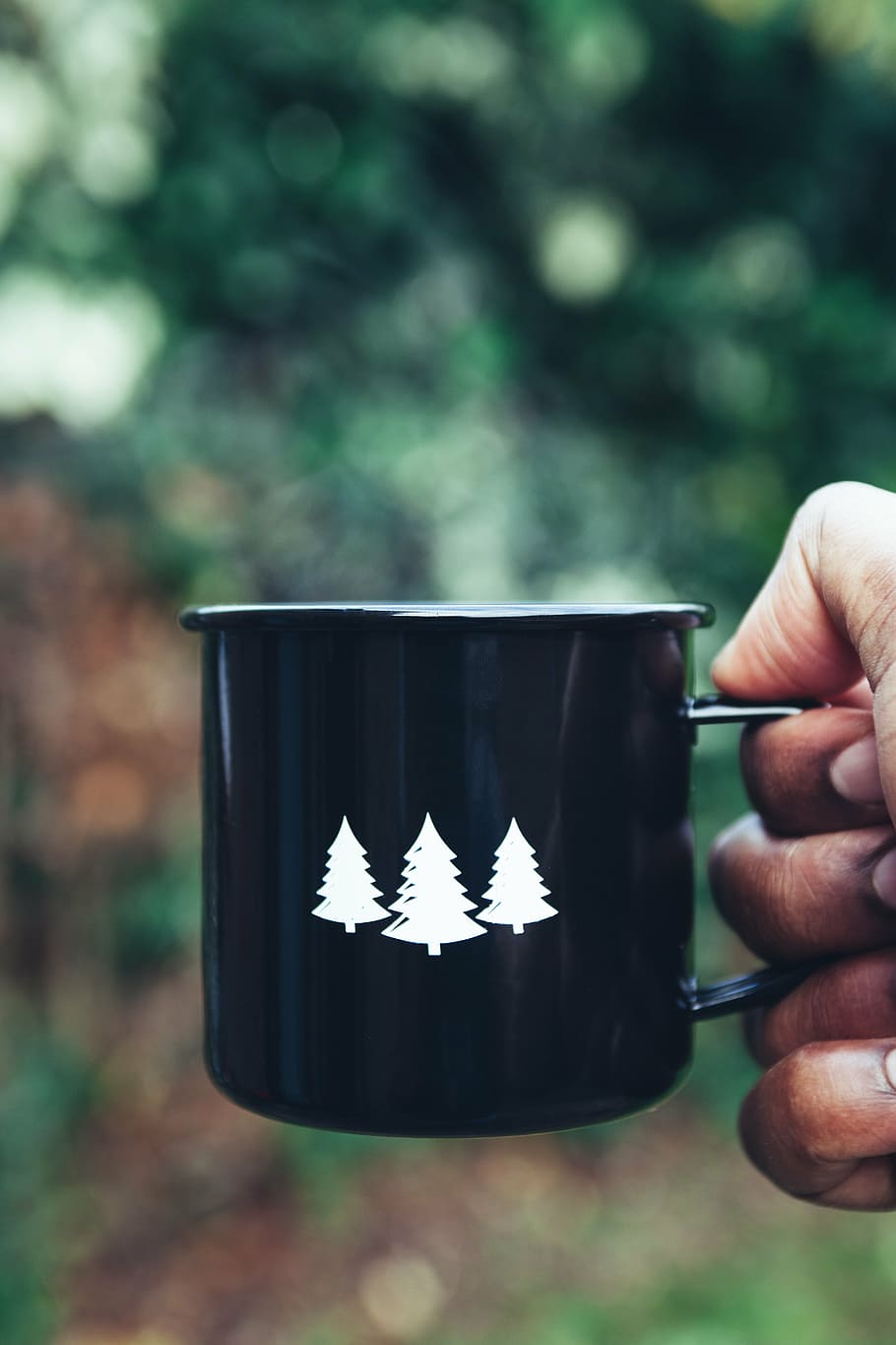 person, holding, black, ceramic, mug, pine trees print, pine, tree, print, hot
