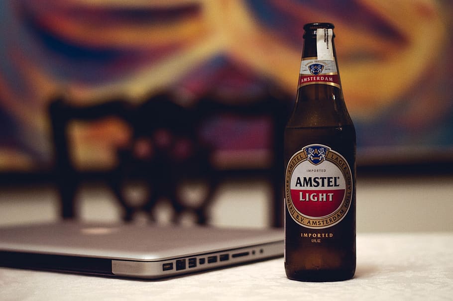 amstel, brewery, beverage, laptop, computer, electronic, text, focus on foreground, close-up, table