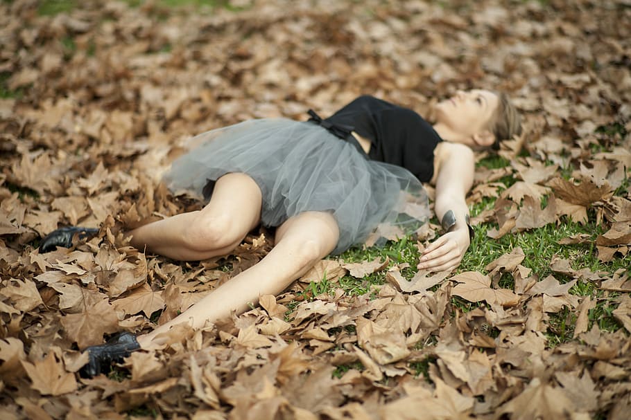 woman, black, gray, tulle dress, lying, pile, withered, leaves, tilt, lens