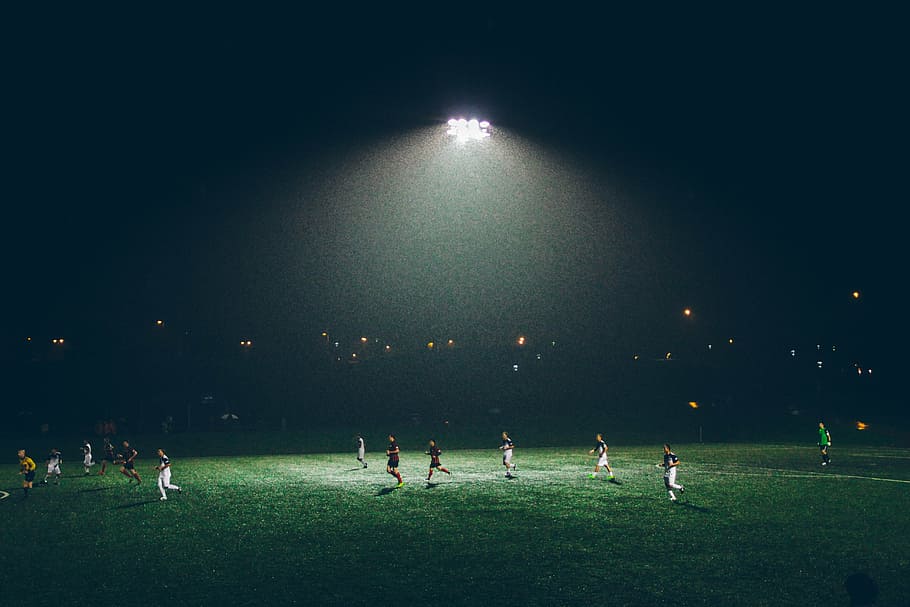 people, grass field, nighttime, soccer, field, group, playing, athletes, sports, game