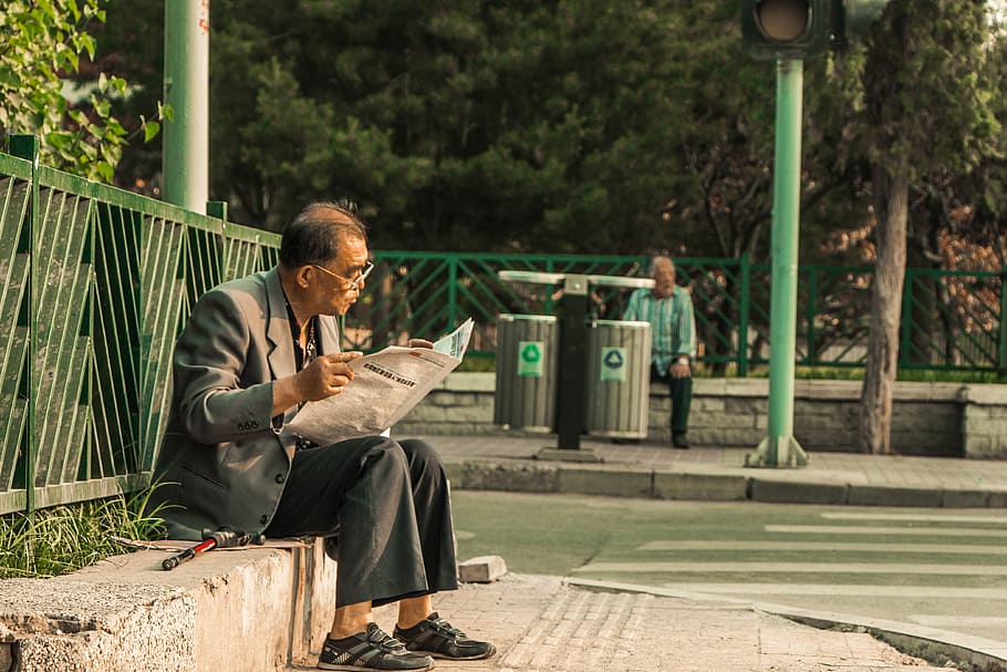 man reading newspaper, road, reading newspapaer, newspaper, man, street, old man, asian, sitting, reading