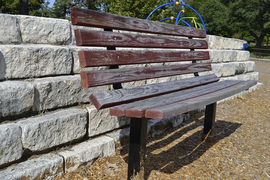 park bench, brick wall, clean, gravel, peaceful, 90 degree angle, brown, wood, wooden, bench