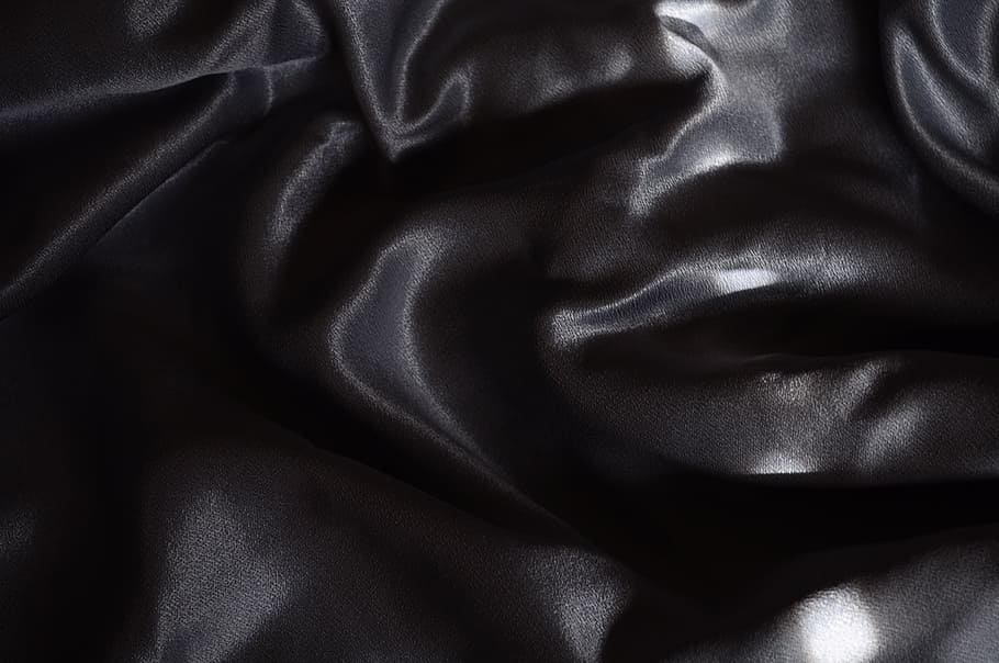 black textile, black, textile, satin, fabric, human body part, one person, human face, studio shot, close-up