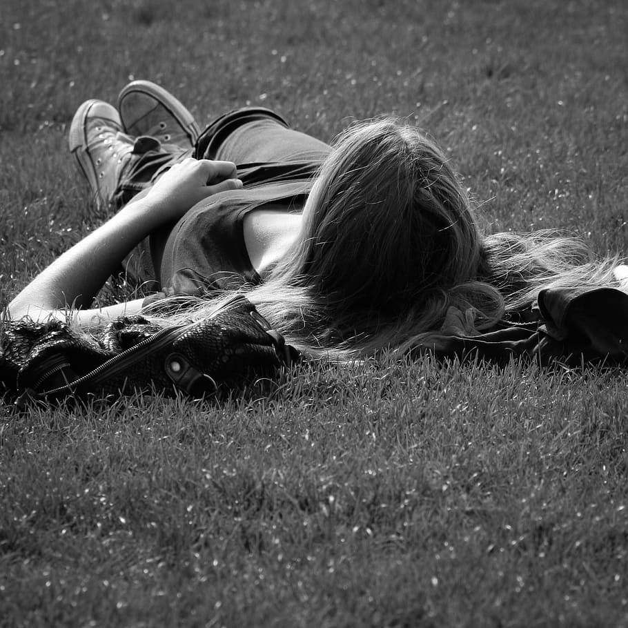 grayscale photo, woman, lying, grass, paris, garden of the invalides, sunbathing, rest, relax, lying down