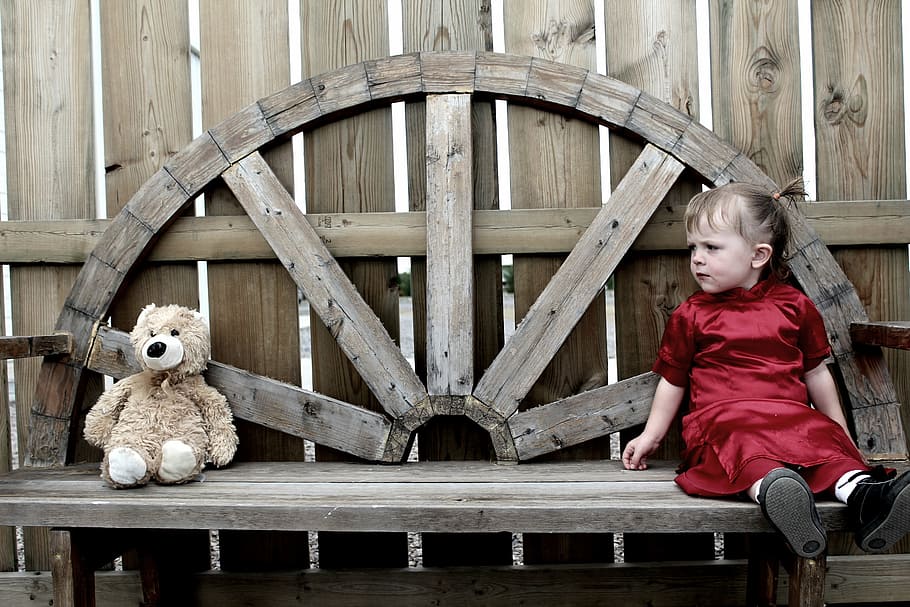 girl, sitting, brown, wooden, bench, looking, bear, plush, toy, teddy