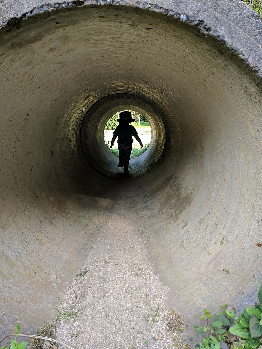 kids, tunnel, shadow, real people, lifestyles, one person, full length, architecture, leisure activity, men