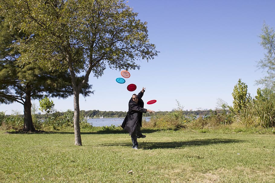 frisbees, lake, stop motion, full length, plant, tree, one person, day, balloon, nature