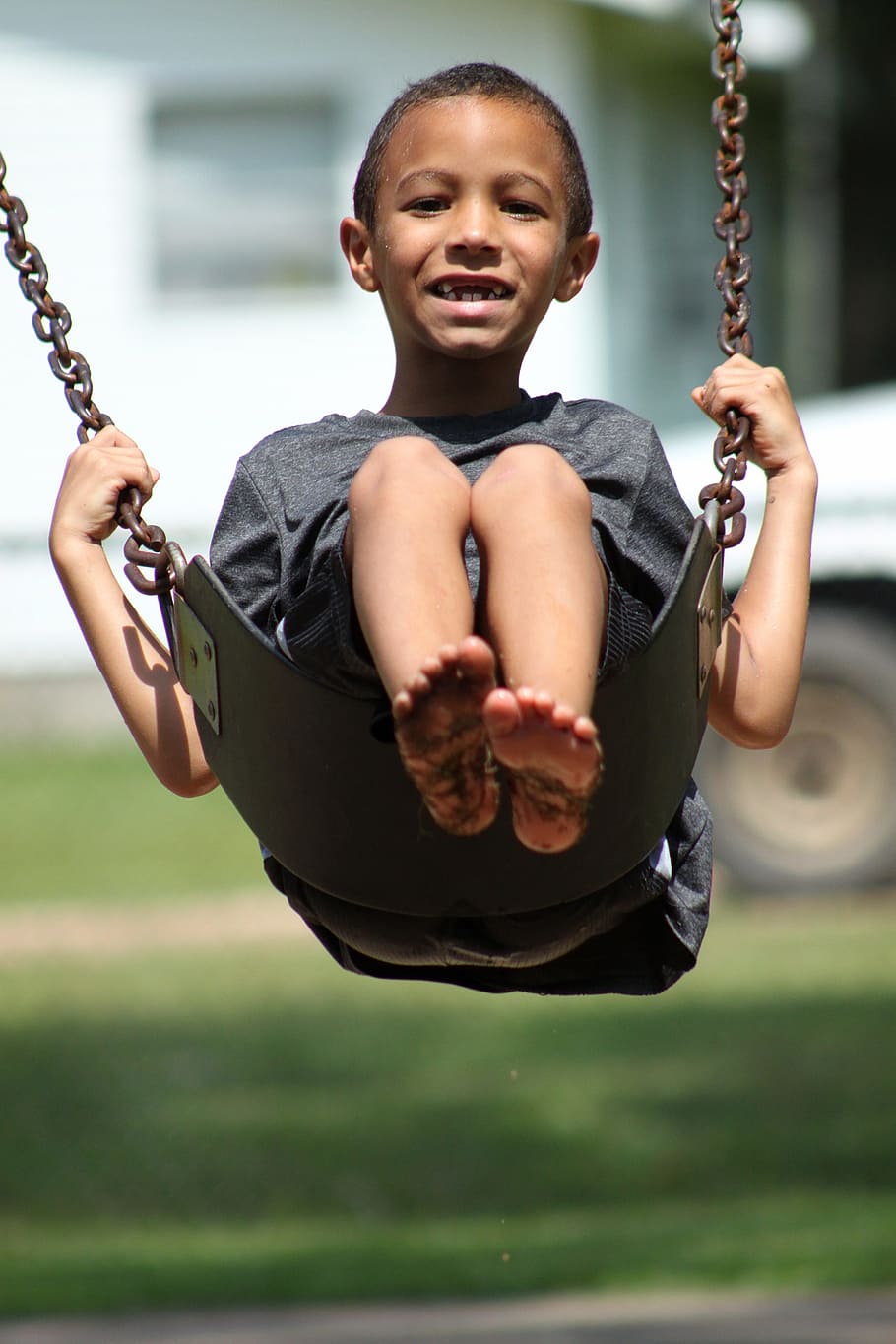boy, wearing, heather-gray crew-neck t-shirt, sitting, swing chair, kid, swinging, young, swing, outside