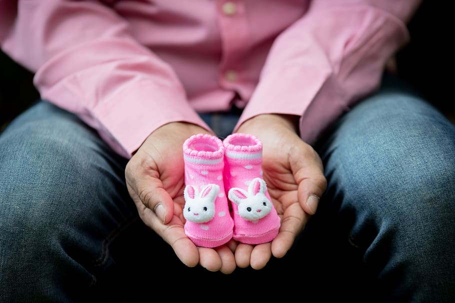 person, wearing, pink, dress shirt, holding, pair, booties, expecting, baby, pregnancy