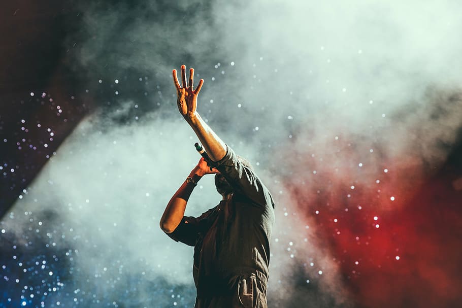 man holding microphone, concert, singer, singing, stage, lights, spotlight, music, band, smoke