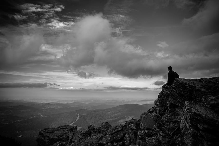 man, sitting, rocky, cliff, looking, mountains, grayscale photography, ledge, wonder, dark
