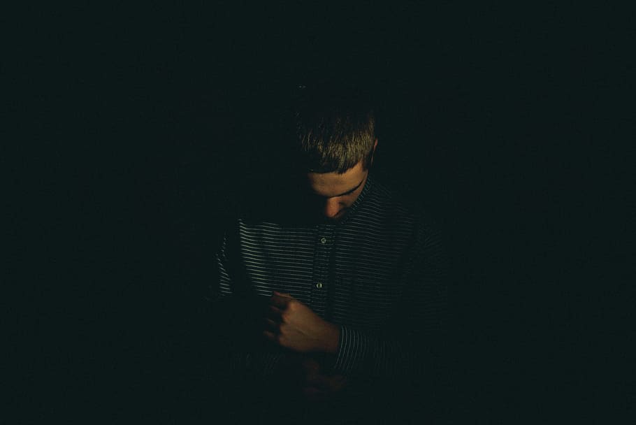 man, looking, holding, clothes sleeves, low light, people, sad, alone, one person, dark