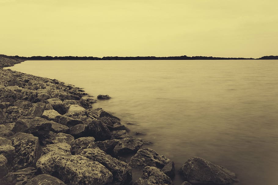 grayscale photo, seashore, sky, daytime, landscape, photography, stone, sea, lake, water
