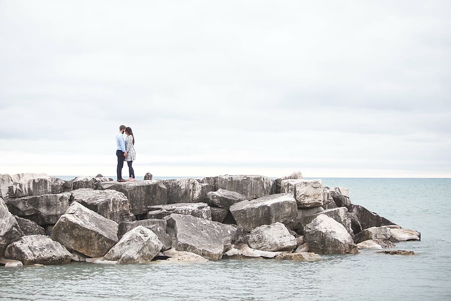 couple, standing, coastal, rocks, jetty, white, sky, ocean, sea, water