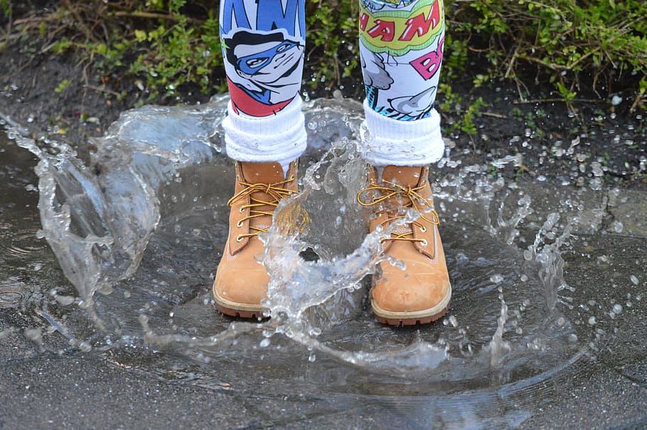 person, wearing, brown, leather boots stumping, puddle, water, gray, surface, daytime, Water, Shoe