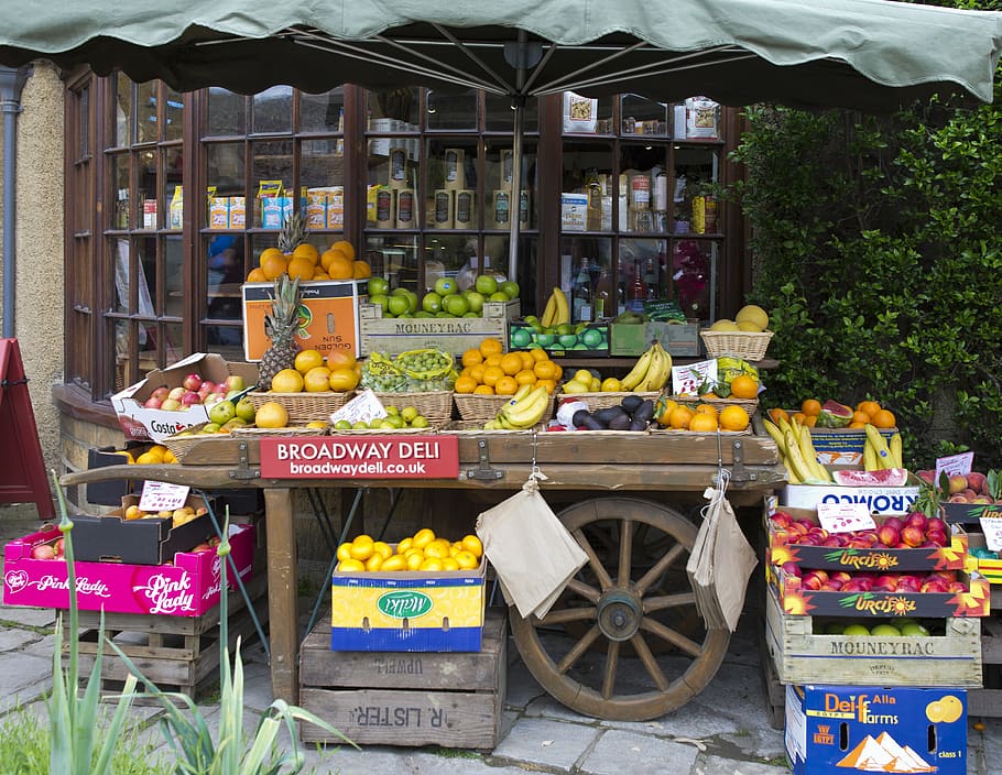 fruiterer's handcart, apples, oranges, bananas, melons, tangerines, old fruit boxes, shop window, stone paving, broadway