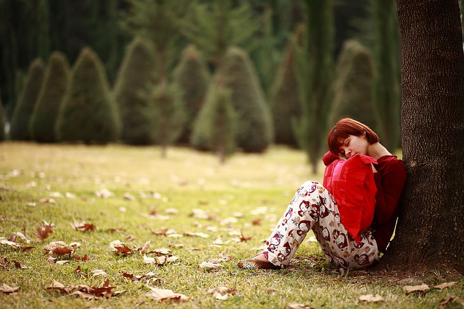 woman, holding, pillow, leaning, tree photo, tree, sleep, sleepwalking, park, grass
