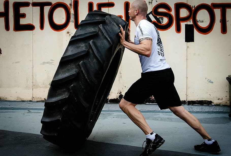 man, carrying, vehicle tire, tyre flipping, hardcore training, crossfit, fitness, gym, workout, training