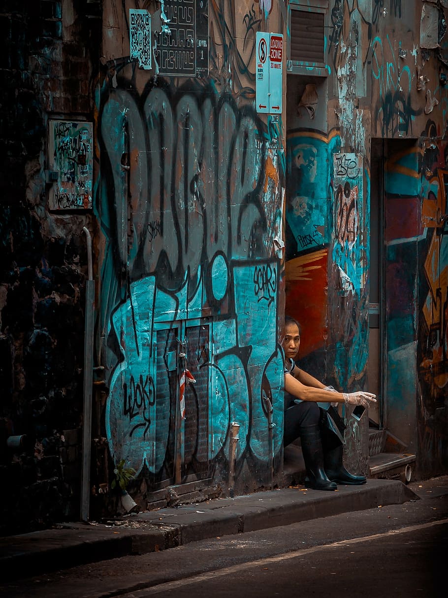 person, sitting, grey, concrete, pavement, wall, art, mural, painting, graffiti