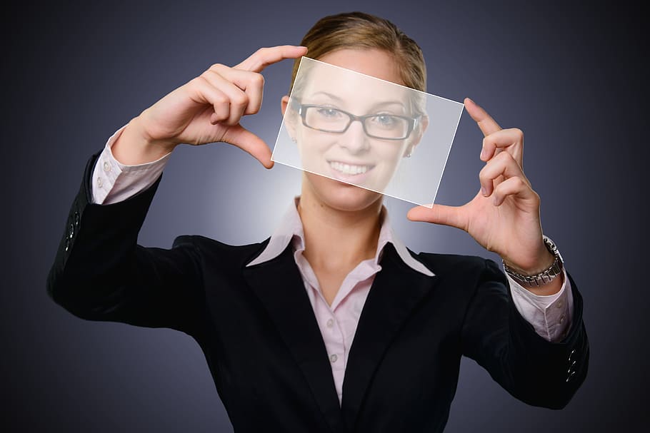 woman, wearing, black, framed, eyeglasses, blazer, holding, glass panel, hiringc, feedback