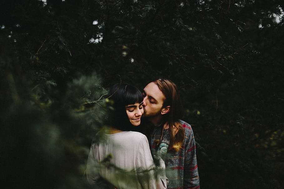 man, kissing, woman, left, cheek, photography, daytime, tree, plant, nature