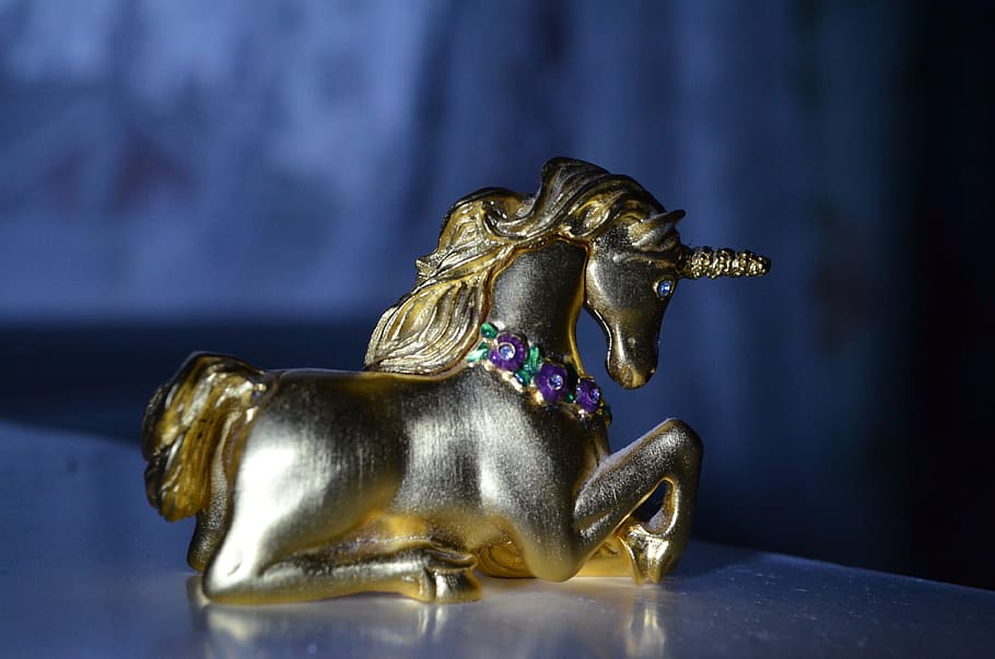 brass figurine, unicorn, closeup, photography, placed, white, table, brass, figurine, closeup photography
