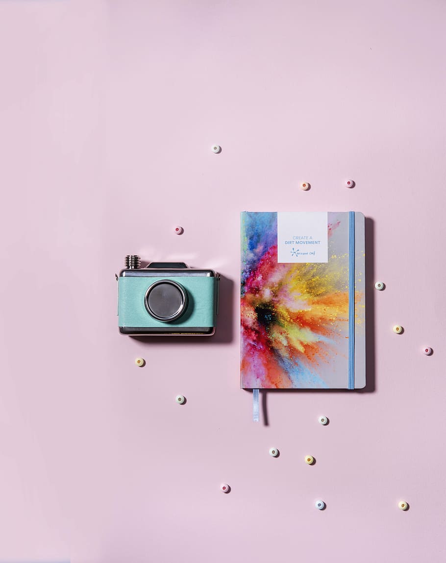 teal, silver-colored milc camera, paint powder burst book, cover, pink, surface, gray, camera, still, items