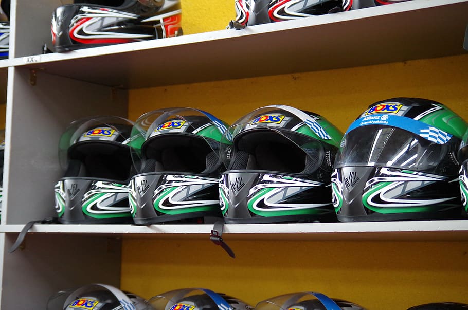 helmet, race, go karts, indoors, large group of objects, shoe, side by side, multi colored, shelf, in a row