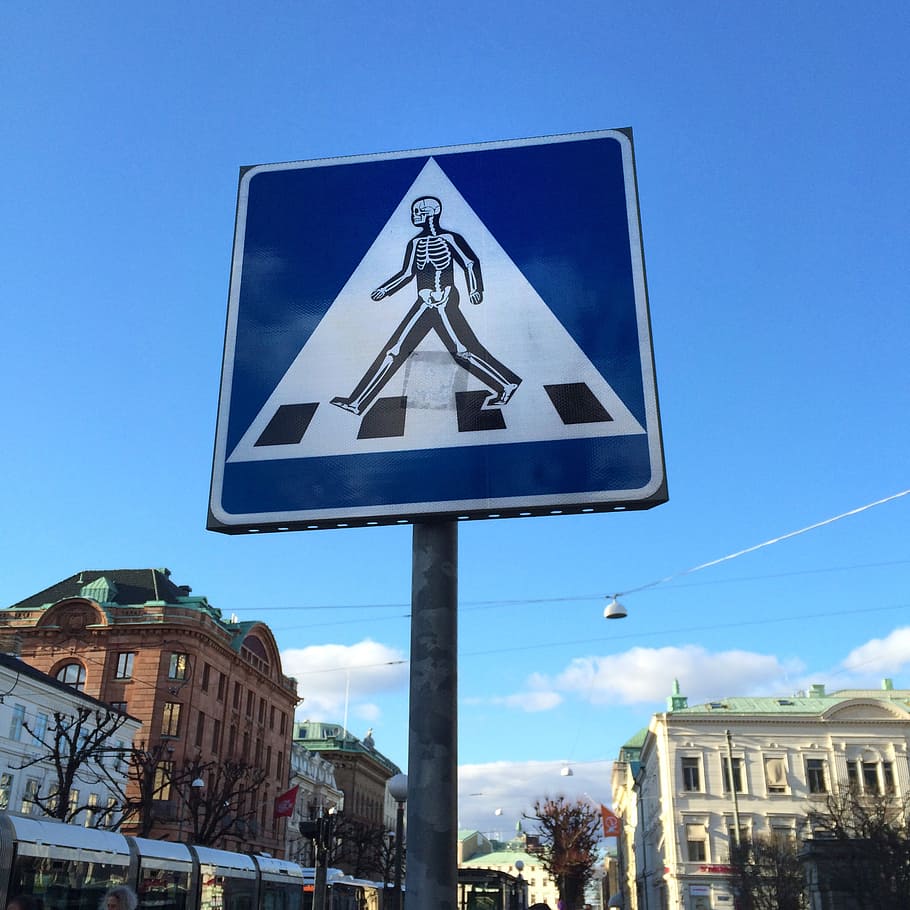 pedestrian crossing, road sign, sticker, traffic, road, thinking about staying, skeletal, sign, street, mr gårman