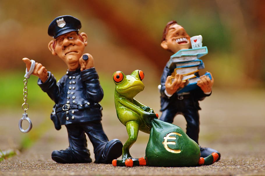 two, policemen, frog figurines, taxes, tax evasion, police, handcuffs, scam, tax consultant, finance