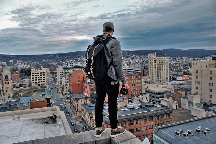 man, black, backpack, standing, edge, building, cloudy, sky, daytime, buildings