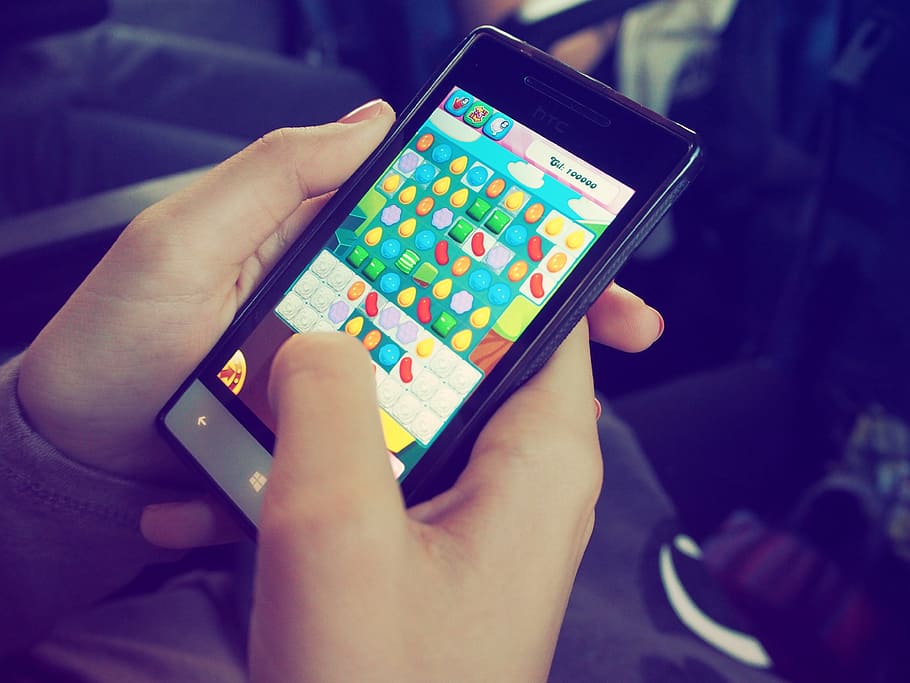 person, holding, windows phone, candy crush, device, electronics, game, hands, mobile phone, screen