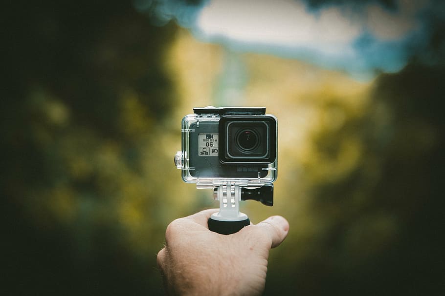 person, holding, black, action camera, camera, gopro, photography, adventure, travel, hand