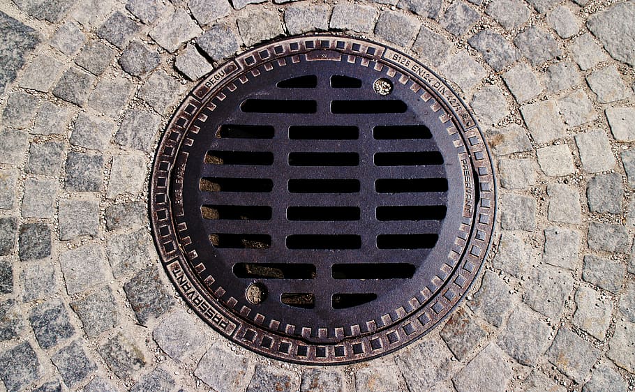 black, metal manhole lid, gulli, gullideckel, manhole covers, channel, sewage system, wastewater, circle, geometric shape