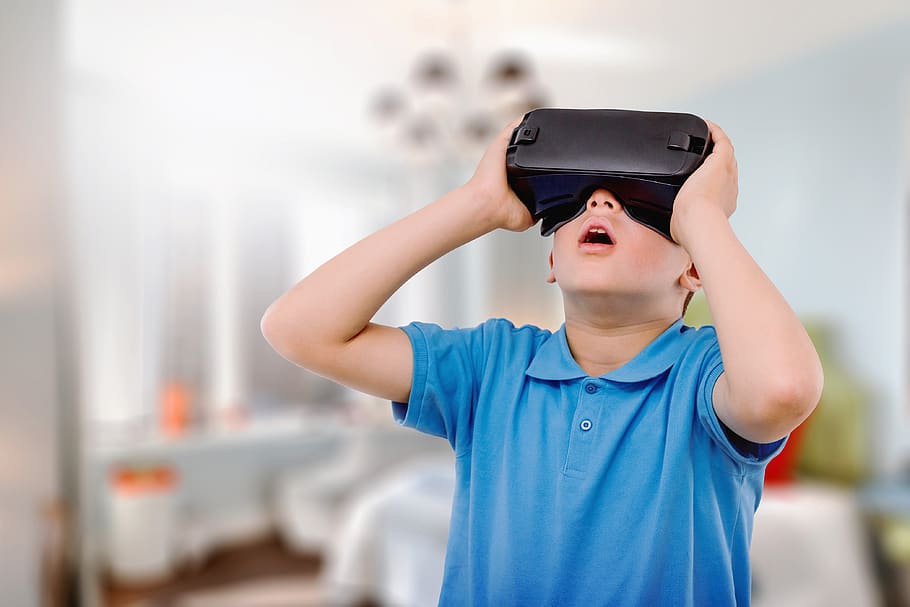 Amazed Teen Boy Wearing Virtual Reality Goggles Watching Movies