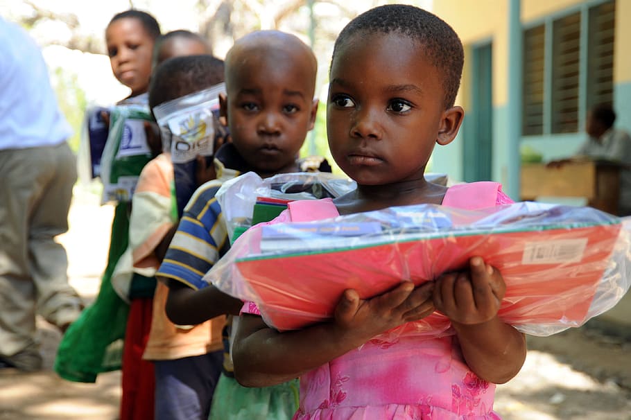 children, holding, school supply packs, tanga, tanzania, care packets, boys, outside, child, childhood
