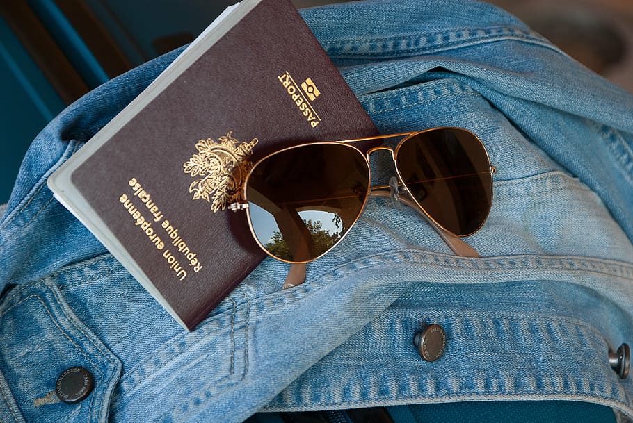 gold, framed, aviator-style sunglasses, passport, travel, holiday, customs, sunglasses, vacations, jeans